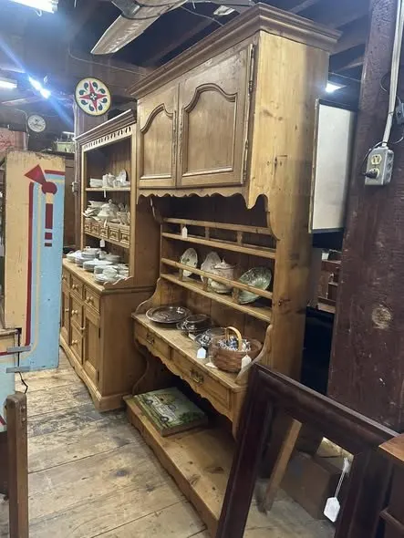 Pine dresser with open shelves holding pottery and bowls